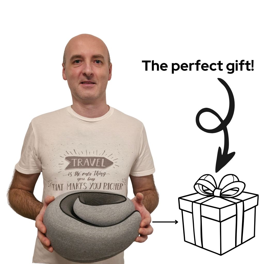 Man holding the Beyond Travel Pillow, an ergonomic and adjustable memory foam neck pillow ideal for gifting. Promotes comfort and neck support on the go.